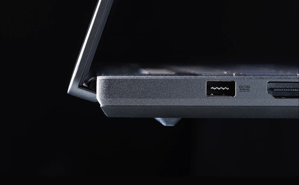 An extreme close-up of the power port and the stealth hinge design of an Eclipse Grey Zephyrus G16.