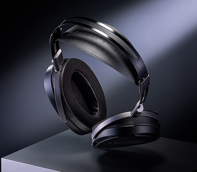 Top view of the ROG臻世headset is displayed on a pedestal, illuminated by a spotlight against a dark background, showing the extended padded headband
