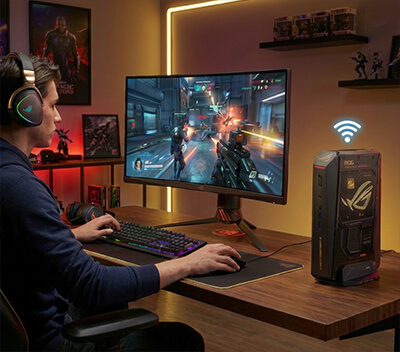 gamer playing AAA games with ROG NUC edition 20 and a WiFi symbol floating on top