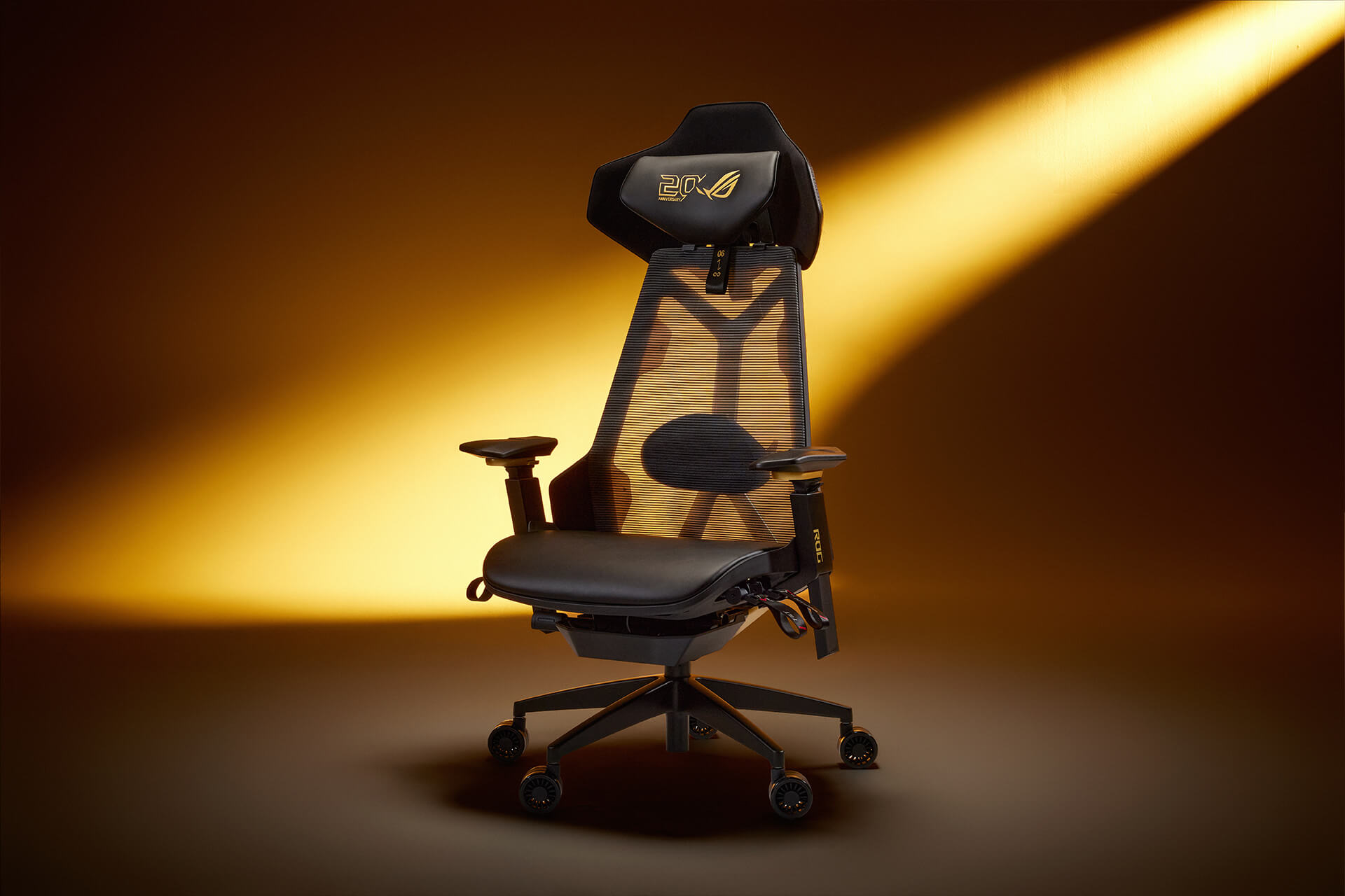 Front view of the ROG Destrier Edition 20 gaming chair, illuminated by ambient gold lightin
