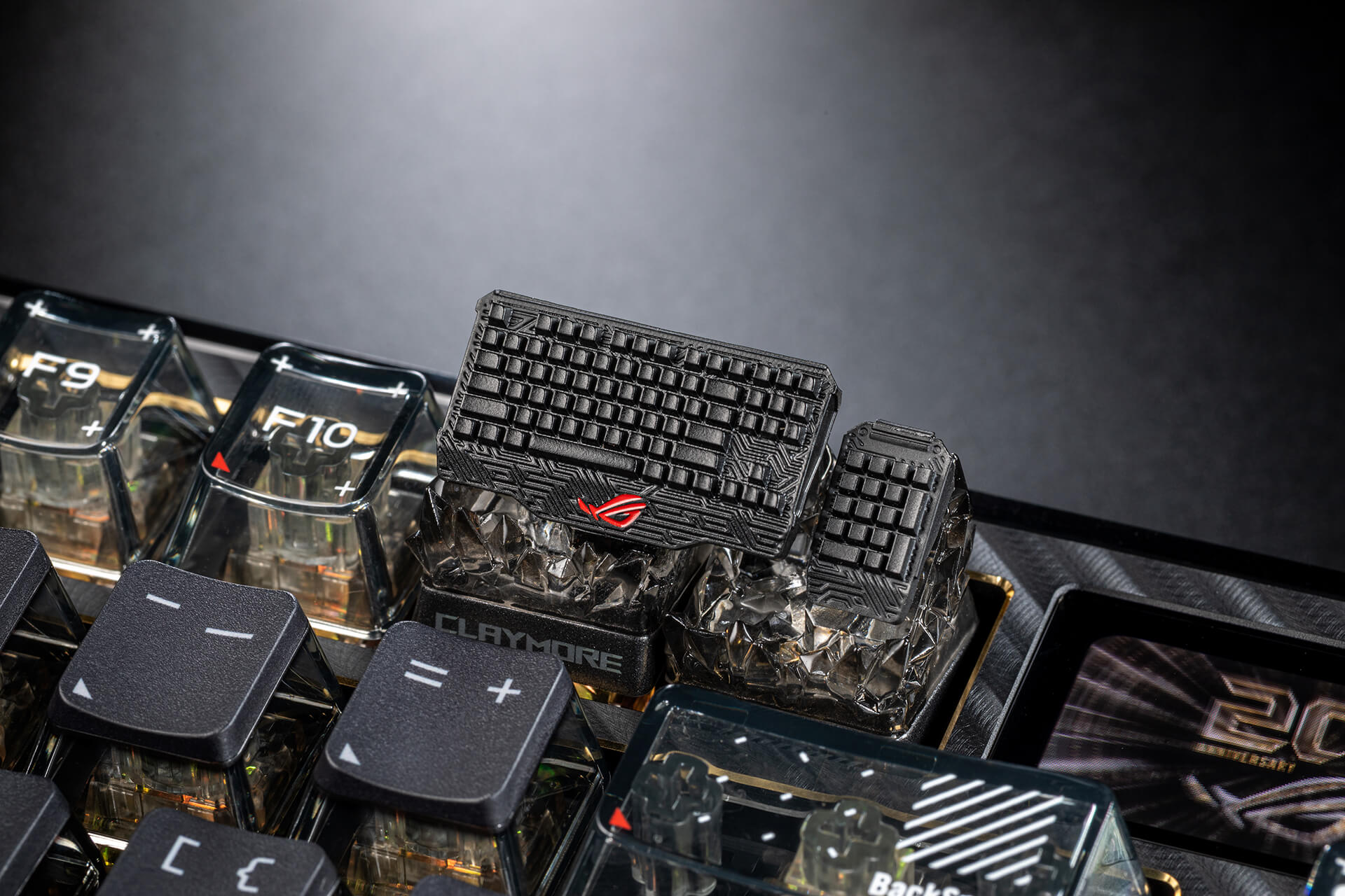 ROG Claymore keycaps placed on F11 F12 key of a keyboard