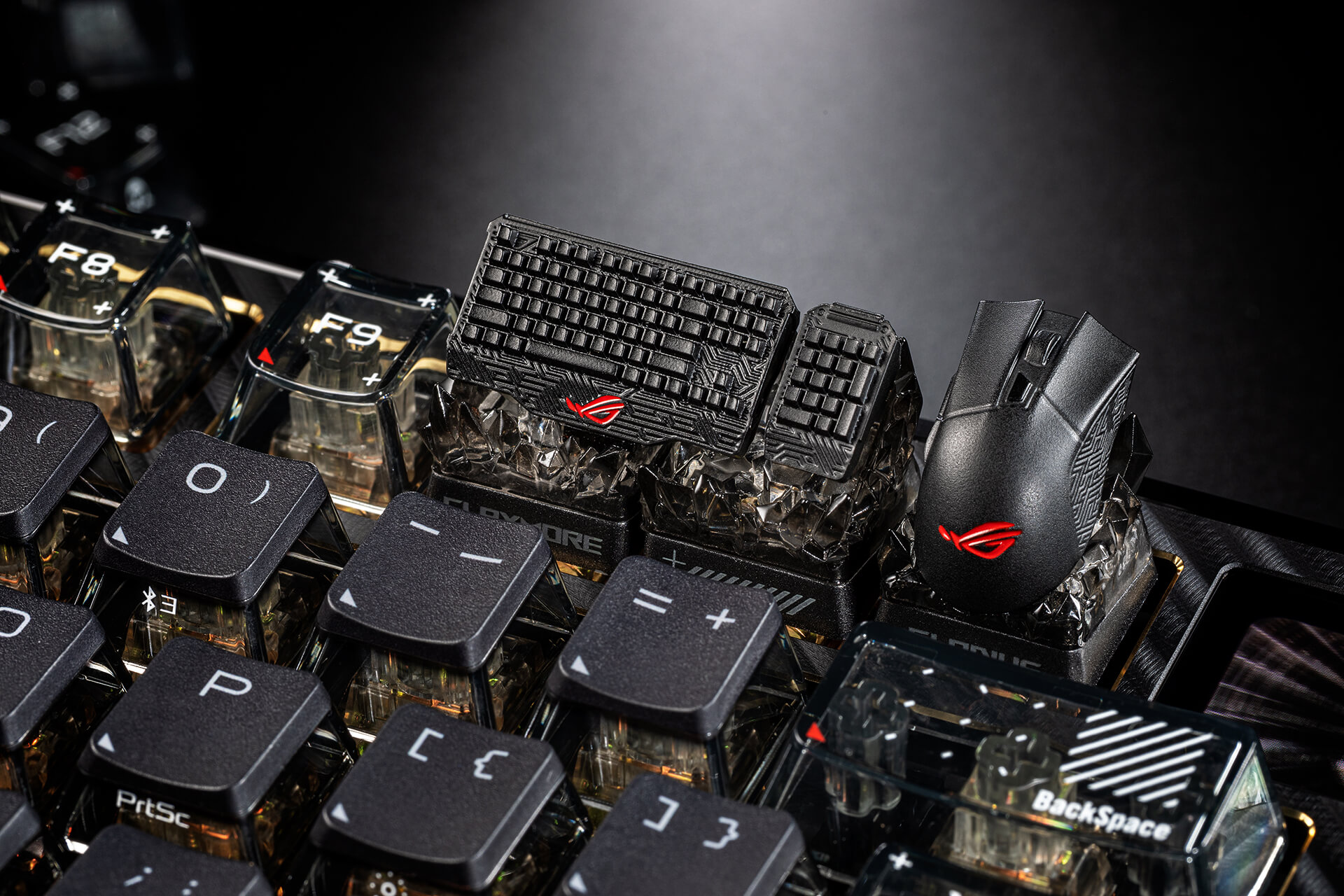 ROG Claymore and ROG Gladius keycap placed on the F10-F12 keys of a keyboard