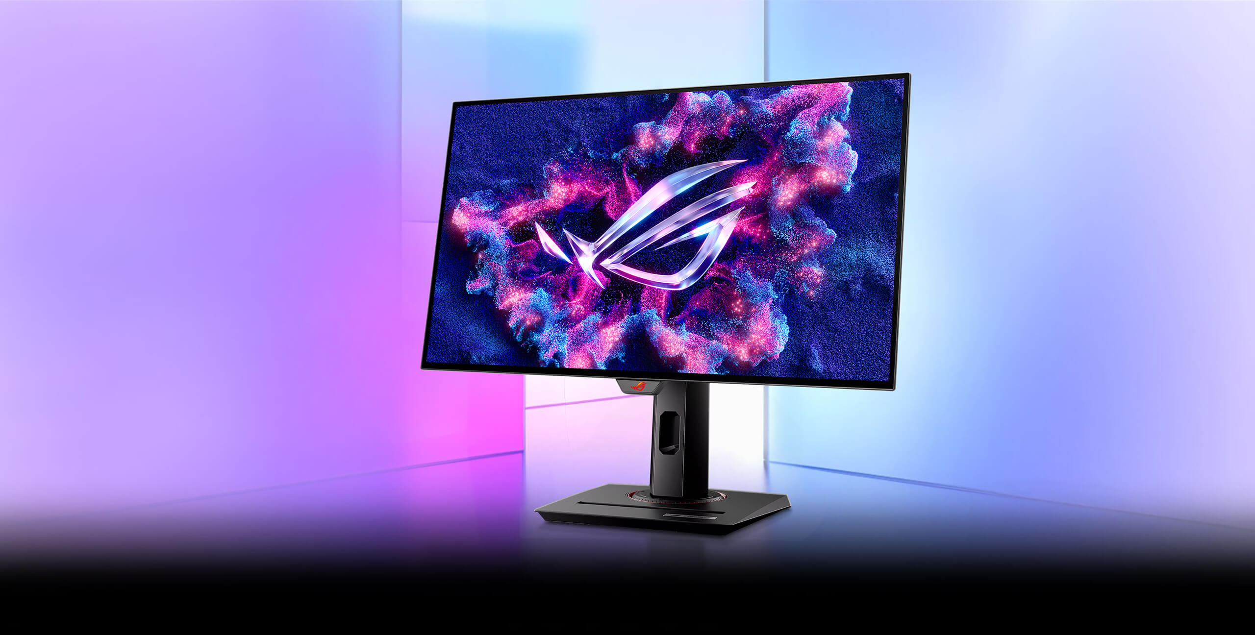 The XG27AQDMG monitor displayed in front of a colorful, glass-textured background.