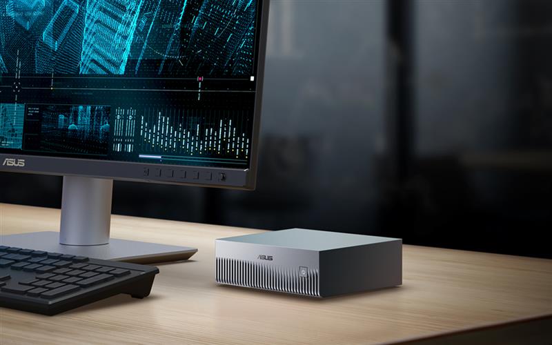 ASUS Ascent GX10 sits on the desk next to monitor along with keyboard