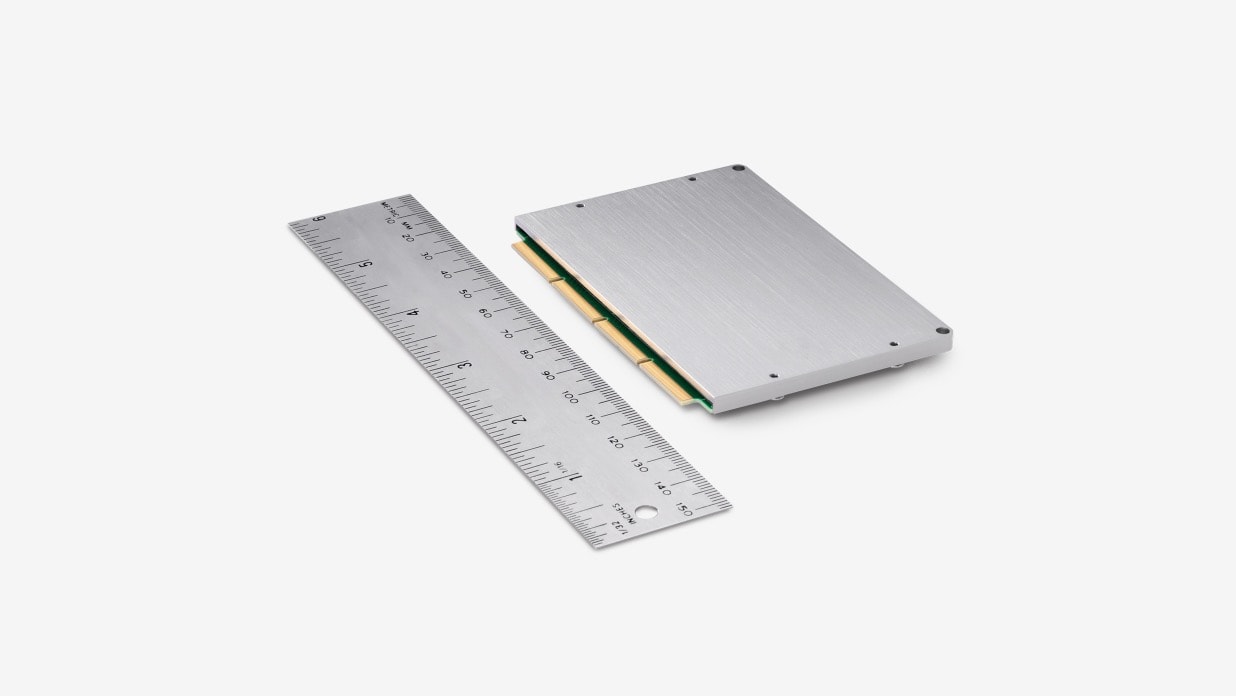 A NUC 12 Compute Element product is placed next to a ruler showing its small dimension.