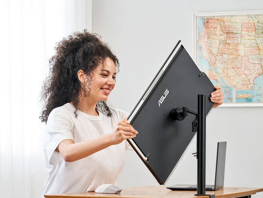 A woman adjusting the angle of ZenScreen MB249C portable pivota