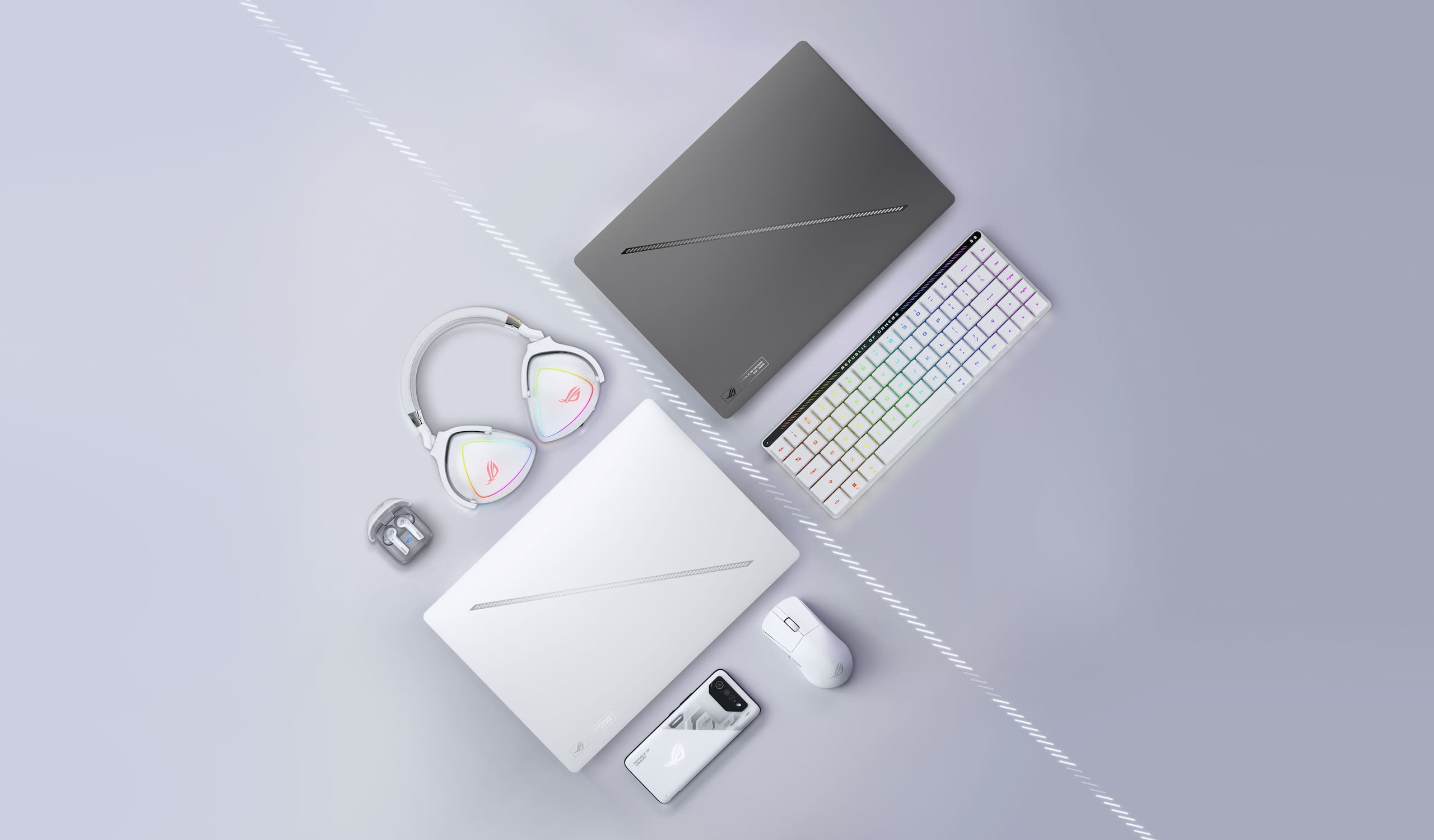 A Platinum White ROG幻16 Air, arranged near an ROG mouse, carrying case, and its power adapter.