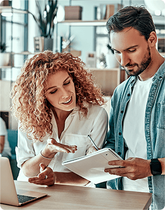 A man and a woman discussing work in a small office