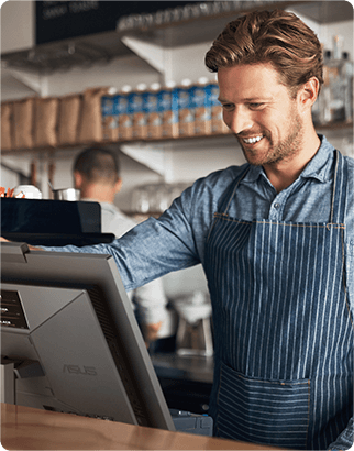 A man standing in front of the POS machine at a café