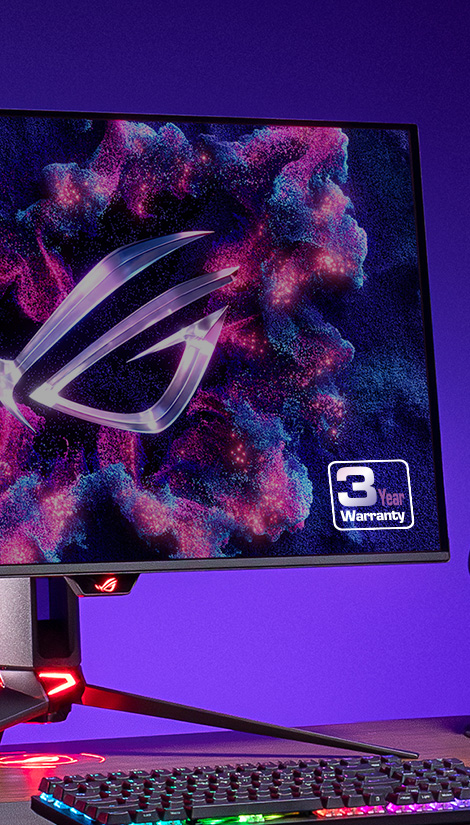 桌上有一个 ROG OLED 显示器和一个键盘。