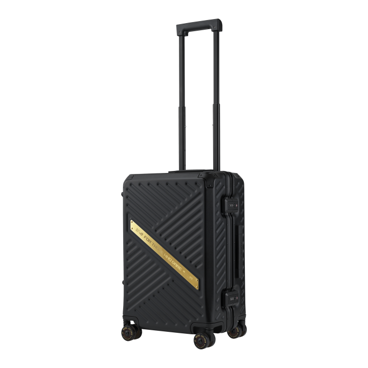 A sleek black ROG gaming suitcase with diagonal textured surface, featuring a gold ROG FOR THOSE WHO DARE plaque and branded wheels